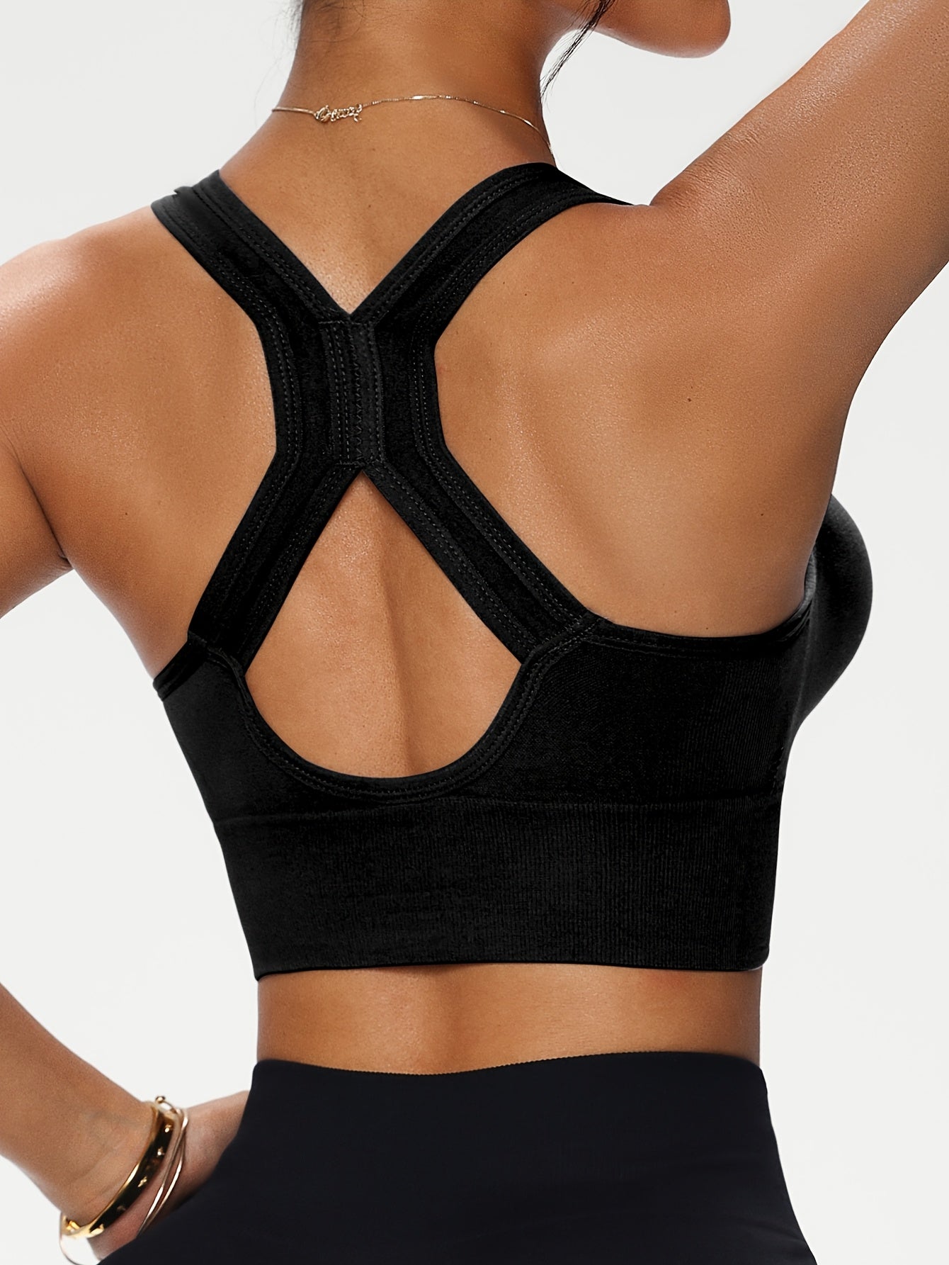 Soutien-gorge féminin sans armature avec fermeture éclair avant, bretelles croisées, coussinets amovibles, confortable et polyvalent pour le sport et un usage quotidien.