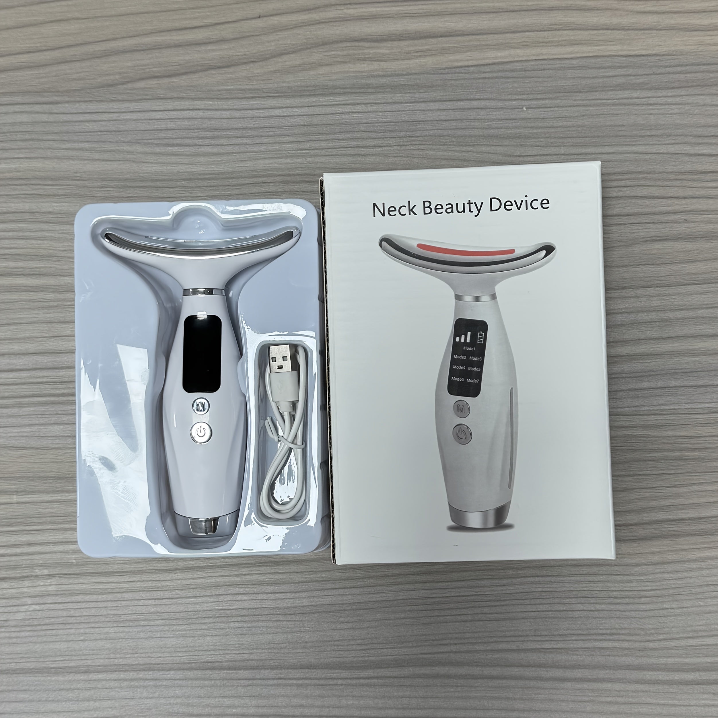 Appareil de soin visage et cou rechargeable, 7 modes, massage vibrant et chauffant, design ergonomique, améliore routine beauté à domicile.