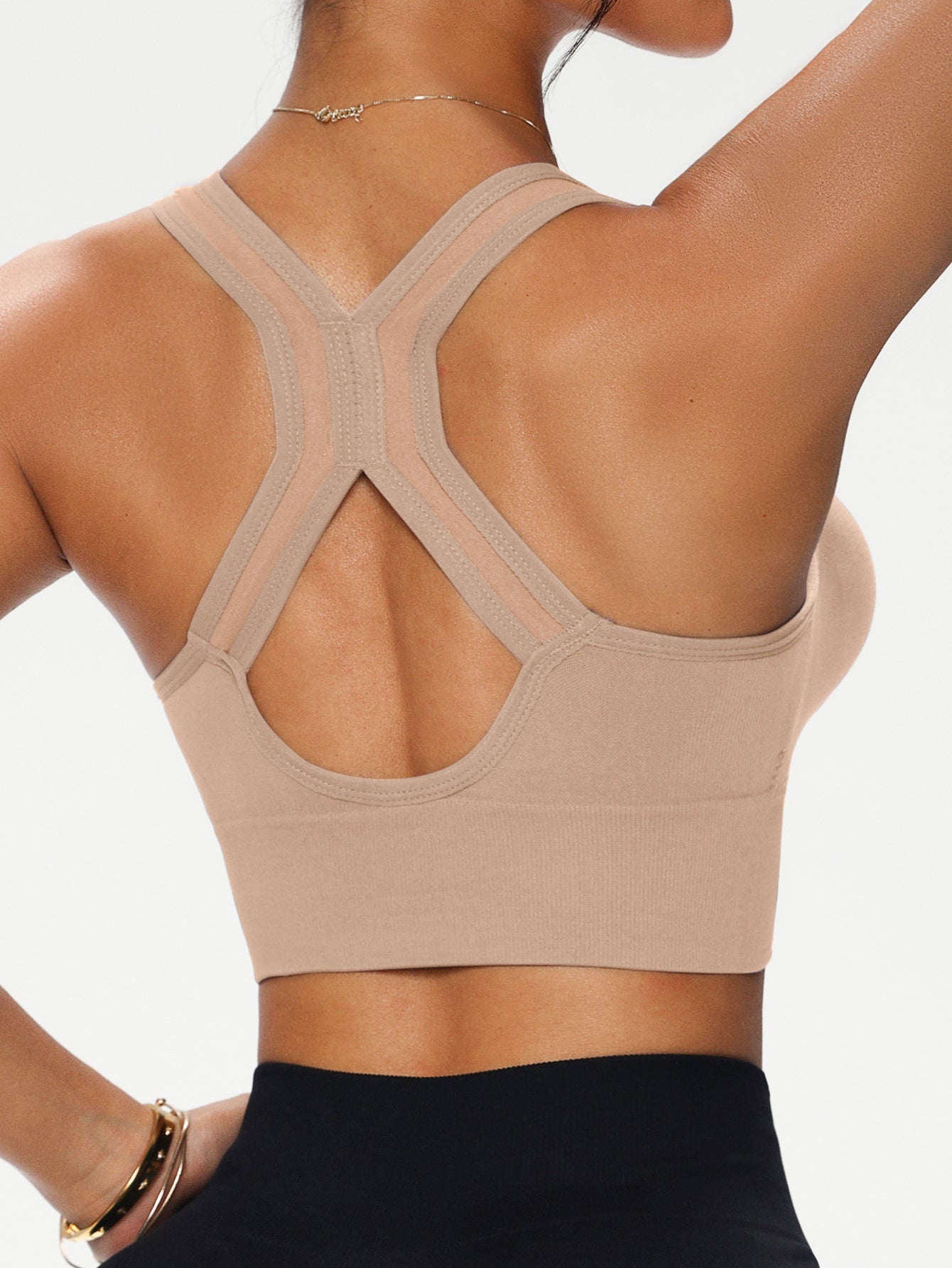 Soutien-gorge féminin sans armature avec fermeture éclair avant, bretelles croisées, coussinets amovibles, confortable et polyvalent pour le sport et un usage quotidien.