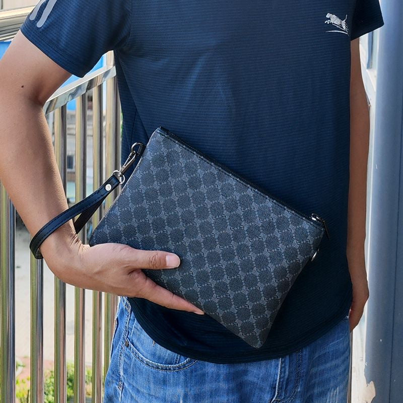 Pochette homme élégante, grande capacité, noire avec fermeture éclair dorée, dragonne poignet, idéale bureau, déplacements quotidiens et style raffiné.